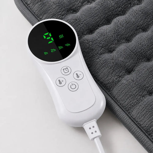 Close-up of a white digital heating pad controller showing temperature settings and timer buttons next to soft plush fabric.