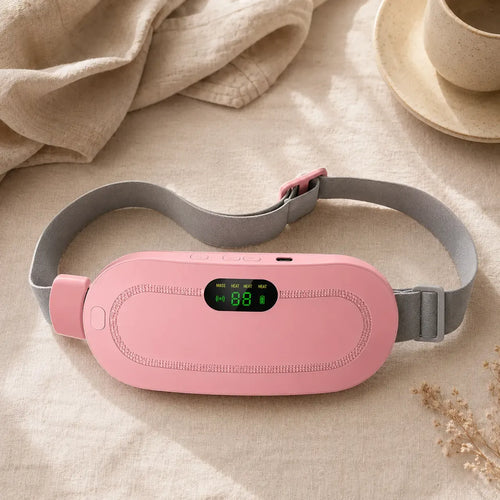 Close up of a pink rechargeable cordless heating pad with an adjustable strap and digital display, designed for menstrual cramps and abdominal pain relief.